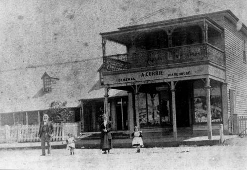 Arhibald in front of his shop