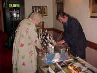 Winnie Wwing MSP making purchase at bookstall manned by Bill MacBride