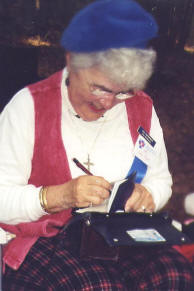 Lucy McPherson writes another postage hero check at the Stone Mountain Highland Games.